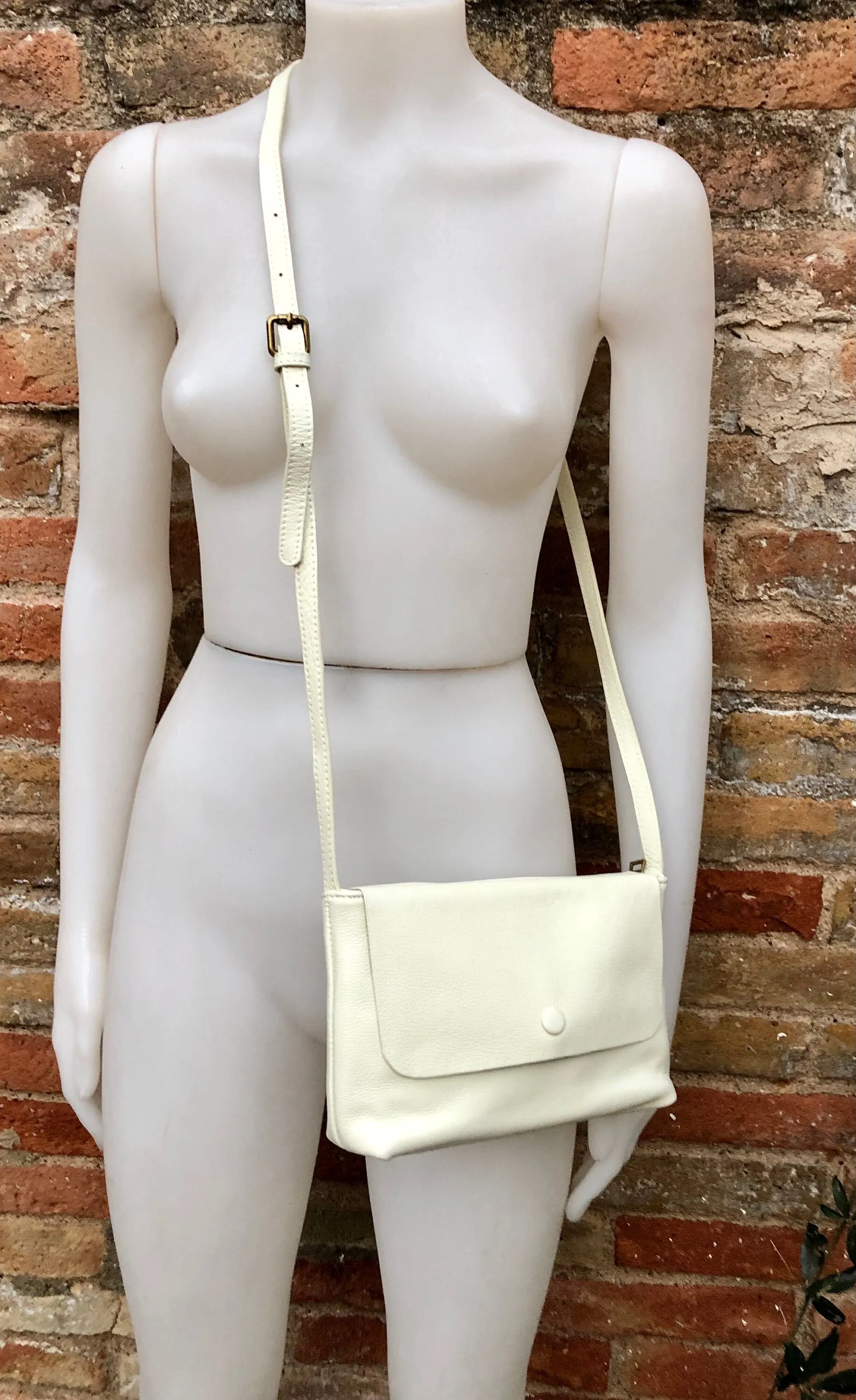 Small leather bag in cream beige. Cross body or shoulder bag in GENUINE leather. Beige leather bag with adjustable strap,  zipper and flap.