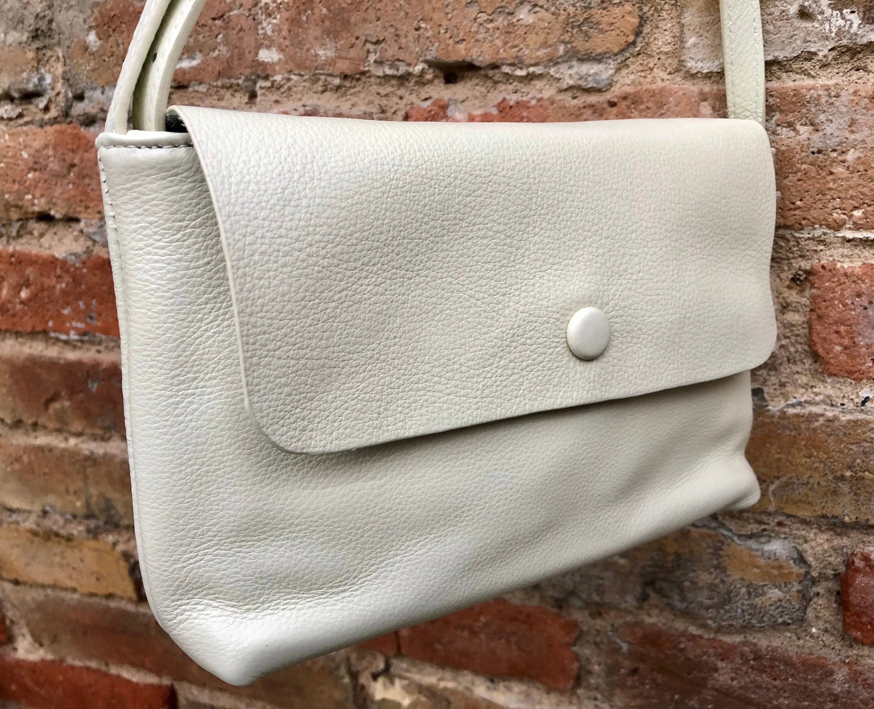 Small leather bag in cream beige. Cross body or shoulder bag in GENUINE leather. Beige leather bag with adjustable strap,  zipper and flap.