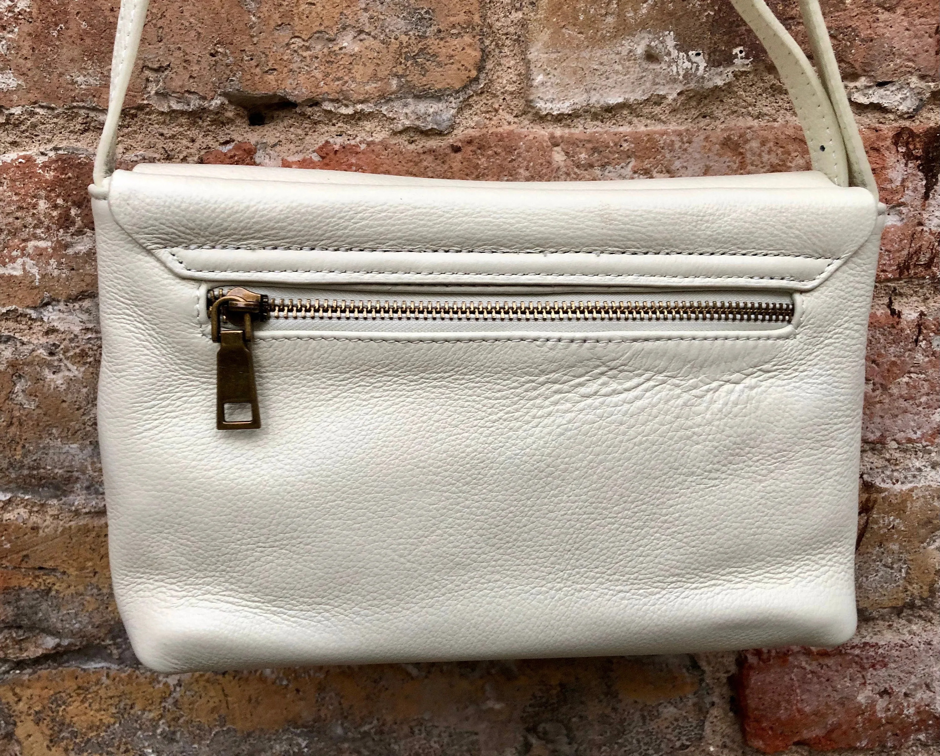 Small leather bag in cream beige. Cross body or shoulder bag in GENUINE leather. Beige leather bag with adjustable strap,  zipper and flap.